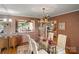 Elegant dining room with glass table, chandelier and ornate accents at 4749 16Th Street Ne Dr, Hickory, NC 28601