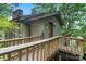 Charming home exterior featuring a wood walkway and a stone chimney among lush trees at 4749 16Th Street Ne Dr, Hickory, NC 28601