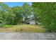 A charming multi-level home nestled amongst mature trees overlooking a grassy slope, perfect for nature enthusiasts at 4749 16Th Street Ne Dr, Hickory, NC 28601