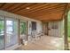 Exterior view of a spacious covered deck with seating, overlooking lush trees and lake views at 4749 16Th Street Ne Dr, Hickory, NC 28601