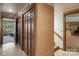 Hallway with wood paneling and floors, leading to a room with large windows at 4749 16Th Street Ne Dr, Hickory, NC 28601
