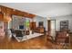 Staged living room featuring hardwood floors, stone fireplace, and natural light at 4749 16Th Street Ne Dr, Hickory, NC 28601