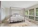 Bright main bedroom with four-poster bed and views to nature at 4749 16Th Street Ne Dr, Hickory, NC 28601