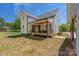 A white home with a covered porch sits on a large green lawn at 5028 Lewis Rd, Gastonia, NC 28052