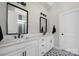 Elegant bathroom with double vanities, modern fixtures, and patterned tile flooring at 5028 Lewis Rd, Gastonia, NC 28052
