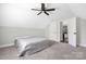 A neutral bedroom features carpeted floor, a ceiling fan, and an ensuite bathroom at 5028 Lewis Rd, Gastonia, NC 28052
