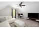 Versatile bonus room features a white sectional, a modern desk, and a large screen TV at 5028 Lewis Rd, Gastonia, NC 28052