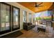Inviting covered patio with wood ceiling, comfortable seating and a ceiling fan for relaxing outdoors at 5028 Lewis Rd, Gastonia, NC 28052