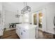 Modern kitchen with a large island, white cabinets, and access to outdoor dining area at 5028 Lewis Rd, Gastonia, NC 28052