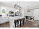 Well-designed kitchen with an island, white cabinets, and contemporary lighting fixtures at 5028 Lewis Rd, Gastonia, NC 28052