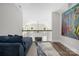 Bright loft space featuring a stylish blue sofa, modern railing, and striking abstract art at 5028 Lewis Rd, Gastonia, NC 28052