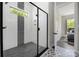 Stylish walk-in shower featuring sleek glass doors and modern tile design at 5028 Lewis Rd, Gastonia, NC 28052