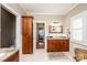 This bathroom has a beautiful vanity area, white tile floors, and wood accents at 5933 Flintlock Ct, Hickory, NC 28601