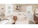 Bright bathroom featuring a soaking tub, tile floors, granite counters, and white wainscotting at 5933 Flintlock Ct, Hickory, NC 28601