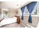 Bright bedroom with two windows, soft carpet, and neutral wall colors at 5933 Flintlock Ct, Hickory, NC 28601
