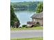 Home featuring a wooden deck overlooking the lake, offering a tranquil outdoor space at 5933 Flintlock Ct, Hickory, NC 28601