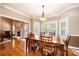 Bright dining room with hardwood floors and views of the fireplace at 5933 Flintlock Ct, Hickory, NC 28601