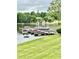 Waterfront home featuring a dock with multiple pontoon boats and scenic views at 5933 Flintlock Ct, Hickory, NC 28601