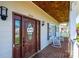 Charming home entrance with a front porch, rocking chairs, and beautiful wood ceiling at 5933 Flintlock Ct, Hickory, NC 28601