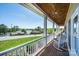 Home features a brick-laid covered porch with rocking chairs and a scenic lake view at 5933 Flintlock Ct, Hickory, NC 28601