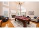 Elegant living room with a fireplace, a pool table, and ample seating at 5933 Flintlock Ct, Hickory, NC 28601