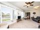 Bright living room featuring large windows with shutters, a ceiling fan, and neutral decor at 5933 Flintlock Ct, Hickory, NC 28601