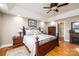 Main bedroom with a tray ceiling, wooden floors, and a decorative bed frame at 5933 Flintlock Ct, Hickory, NC 28601