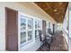 Covered porch with brick flooring and shutters at 5933 Flintlock Ct, Hickory, NC 28601