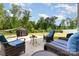 Beautiful backyard with outdoor seating, grill, and lush green lawn perfect for relaxation and entertaining at 6040 Fazio Ct, Harrisburg, NC 28075