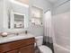 Bathroom with single sink vanity and a shower/tub combo with white and grey shower curtain at 6040 Fazio Ct, Harrisburg, NC 28075