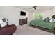 Cozy bedroom featuring a ceiling fan, large window and a stylish dresser at 6040 Fazio Ct, Harrisburg, NC 28075