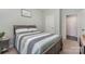 Comfortable bedroom featuring a striped quilt, neutral walls, and soft lighting for a relaxing atmosphere at 6040 Fazio Ct, Harrisburg, NC 28075