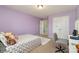 Comfortable bedroom with neutral walls, carpeted floor, closet, and a desk at 6040 Fazio Ct, Harrisburg, NC 28075