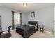 Bedroom with a large window providing natural light at 6040 Fazio Ct, Harrisburg, NC 28075