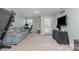 Bright bonus room featuring a comfortable sofa, desk, and large TV for entertainment and relaxation at 6040 Fazio Ct, Harrisburg, NC 28075