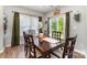 Dining room with hardwood floors, a wooden table, and a sliding glass door leading to the backyard at 6040 Fazio Ct, Harrisburg, NC 28075