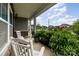 Inviting front porch with rocking chairs and lush landscaping, offering a cozy welcome at 6040 Fazio Ct, Harrisburg, NC 28075