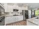 Well-lit kitchen with stainless steel appliances, granite countertops, and white cabinets connected to the dining room at 6040 Fazio Ct, Harrisburg, NC 28075