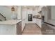 Well-designed kitchen featuring granite countertops, stainless steel appliances, and white cabinets at 6040 Fazio Ct, Harrisburg, NC 28075