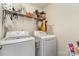 Functional laundry room with side-by-side LG washer and dryer and storage rack, designed for convenience at 6040 Fazio Ct, Harrisburg, NC 28075