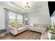 Inviting living room with tray ceilings, large windows, and hardwood floors at 6040 Fazio Ct, Harrisburg, NC 28075