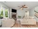Cozy living room with a stone fireplace, hardwood floors, and comfortable seating area at 6040 Fazio Ct, Harrisburg, NC 28075