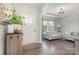 Inviting living room featuring hardwood floors, a bright window, and neutral décor creating a cozy atmosphere at 6040 Fazio Ct, Harrisburg, NC 28075