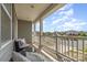 Covered porch with comfy seating and views of the tree-lined neighborhood streets at 6040 Fazio Ct, Harrisburg, NC 28075