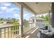 Covered porch with comfortable outdoor seating and views of the quiet neighborhood at 6040 Fazio Ct, Harrisburg, NC 28075