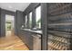 Wet bar area with hardwood flooring, stainless steel appliances, and a gray backsplash at 632 Dorothy Dr, Charlotte, NC 28203