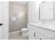 Modern bathroom with glass shower, marble walls, and white vanity at 632 Dorothy Dr, Charlotte, NC 28203