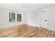 Clean and bright bedroom with hardwood floors, modern lighting, and two windows at 632 Dorothy Dr, Charlotte, NC 28203