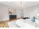 Charming bedroom with hardwood floors, elegant chandelier, and stylish décor at 632 Dorothy Dr, Charlotte, NC 28203