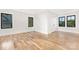Bright, empty bedroom with hardwood floors and black-framed windows at 632 Dorothy Dr, Charlotte, NC 28203